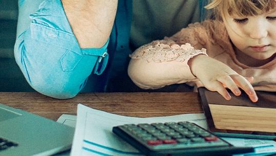 Father and daughter sitting at a desk