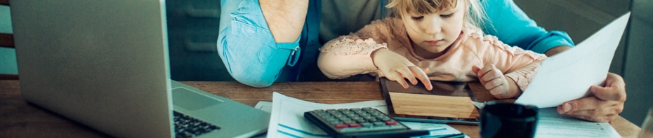 Father and daughter sitting at a desk