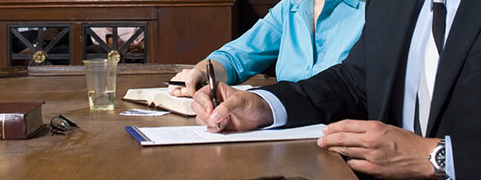 lawyers writing on a notepad