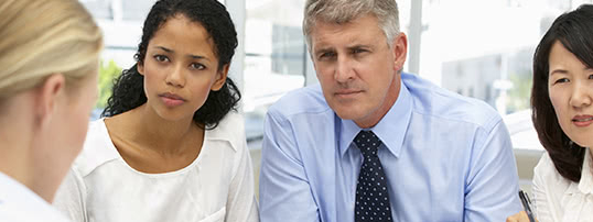 four people chatting in a meeting