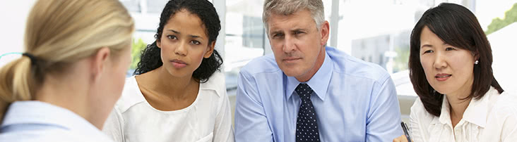 four people chatting in a meeting