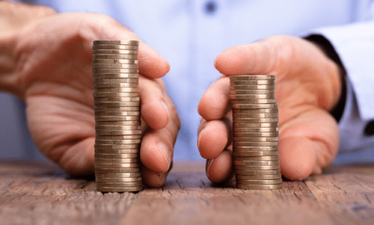 Two stacks of coins being compared.