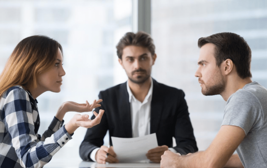 A couple disagree in front of their family lawyer.