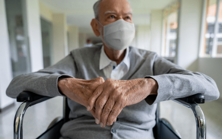 An elderly man in wheelchair in long term care home