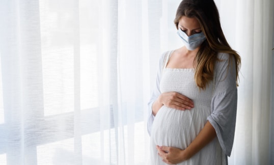 Pregnant woman with mask on