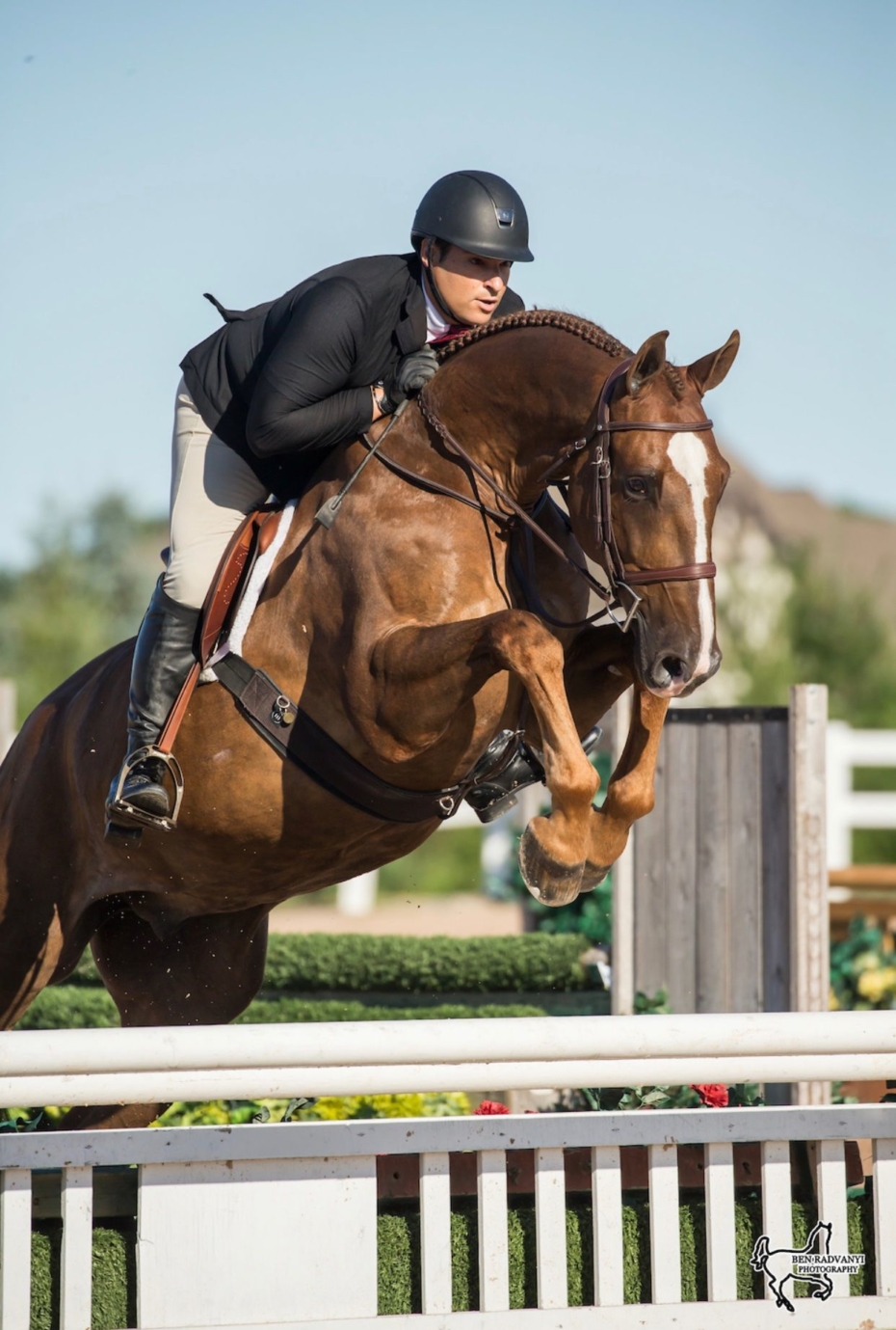 Personal Injury Lawyer Louis DelSignore riding a horse over a jump obstacle