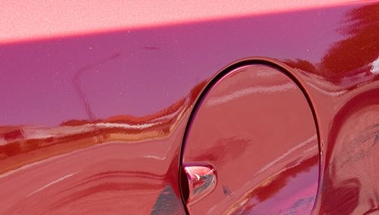 close up image of the side of a car with a dent in it