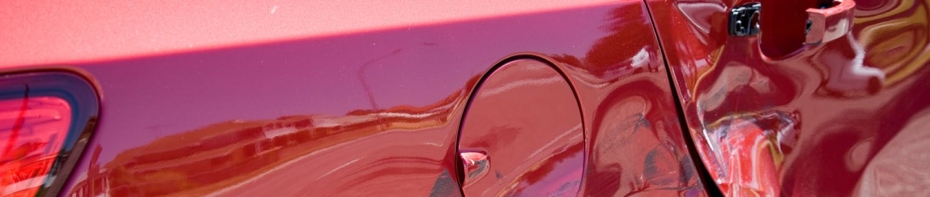 close up image of the side of a car with a dent in it