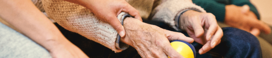 Woman holding elderly man's hand