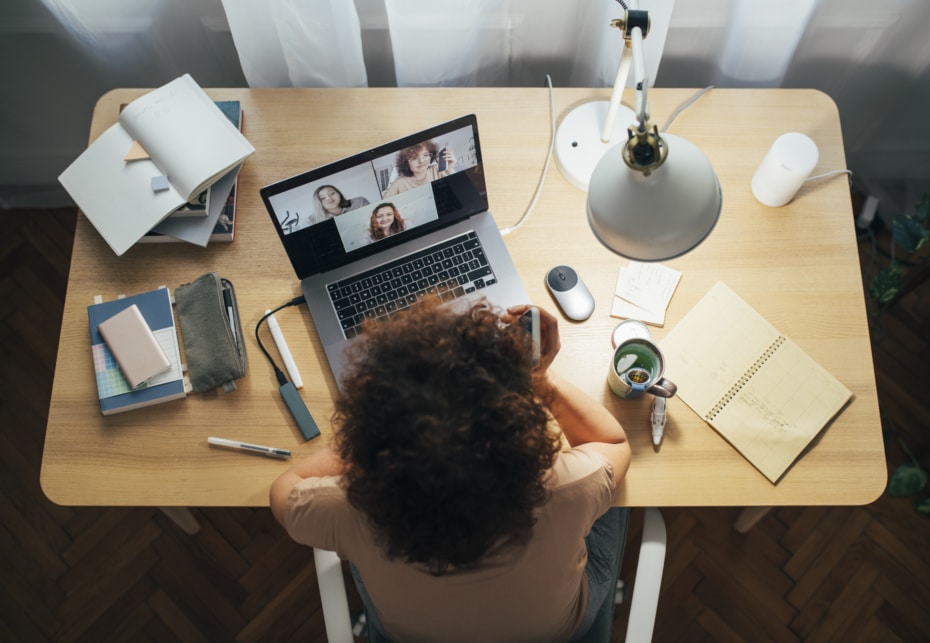 Woman sits at desk of home office