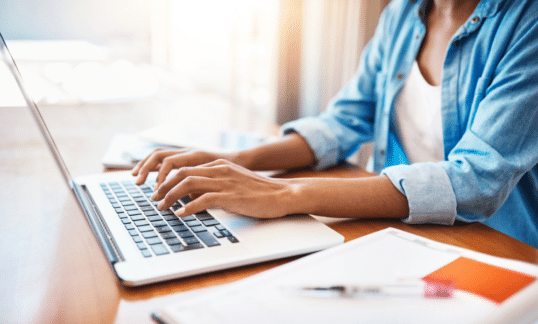 A woman using a laptop to access Settify, a family law service