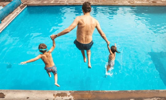 Father and son having fun on the pool