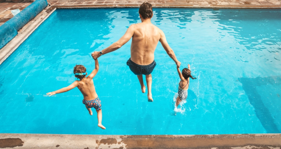 Father and son having fun on the pool
