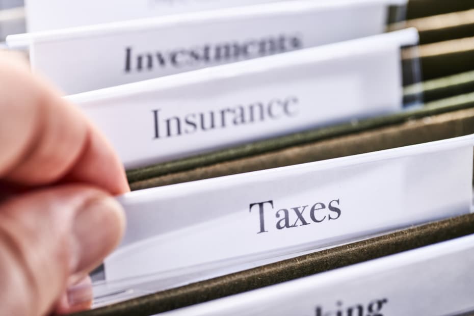 Tax folders in desk drawer with labels and tabs