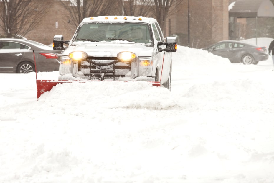 Snow plow removing snow at an apartment complex