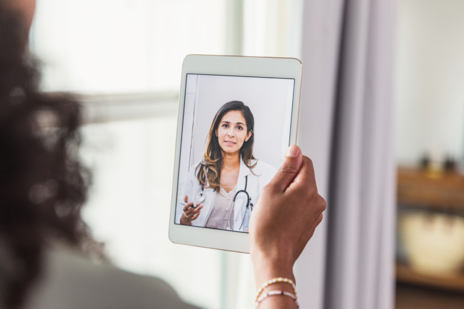 A female doctor offers patient advice during virtual healthcare appointment.