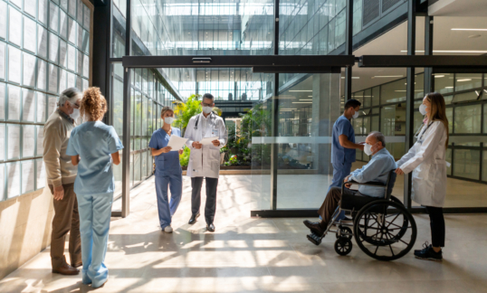 People walking in and out of the hospital - Mental Healthcare concepts