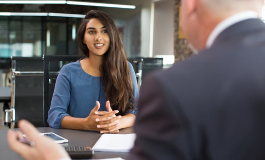 smiling female student interviewing in office