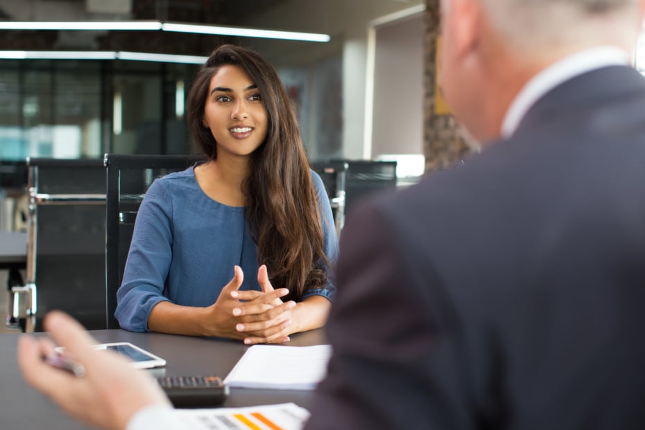 smiling female student interviewing in office