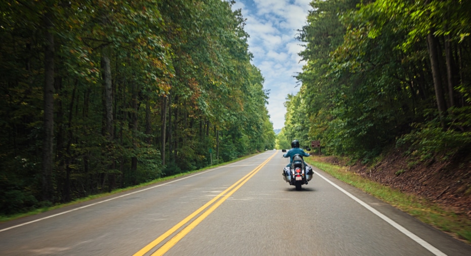 Motorcycle on the road with trees in the summer